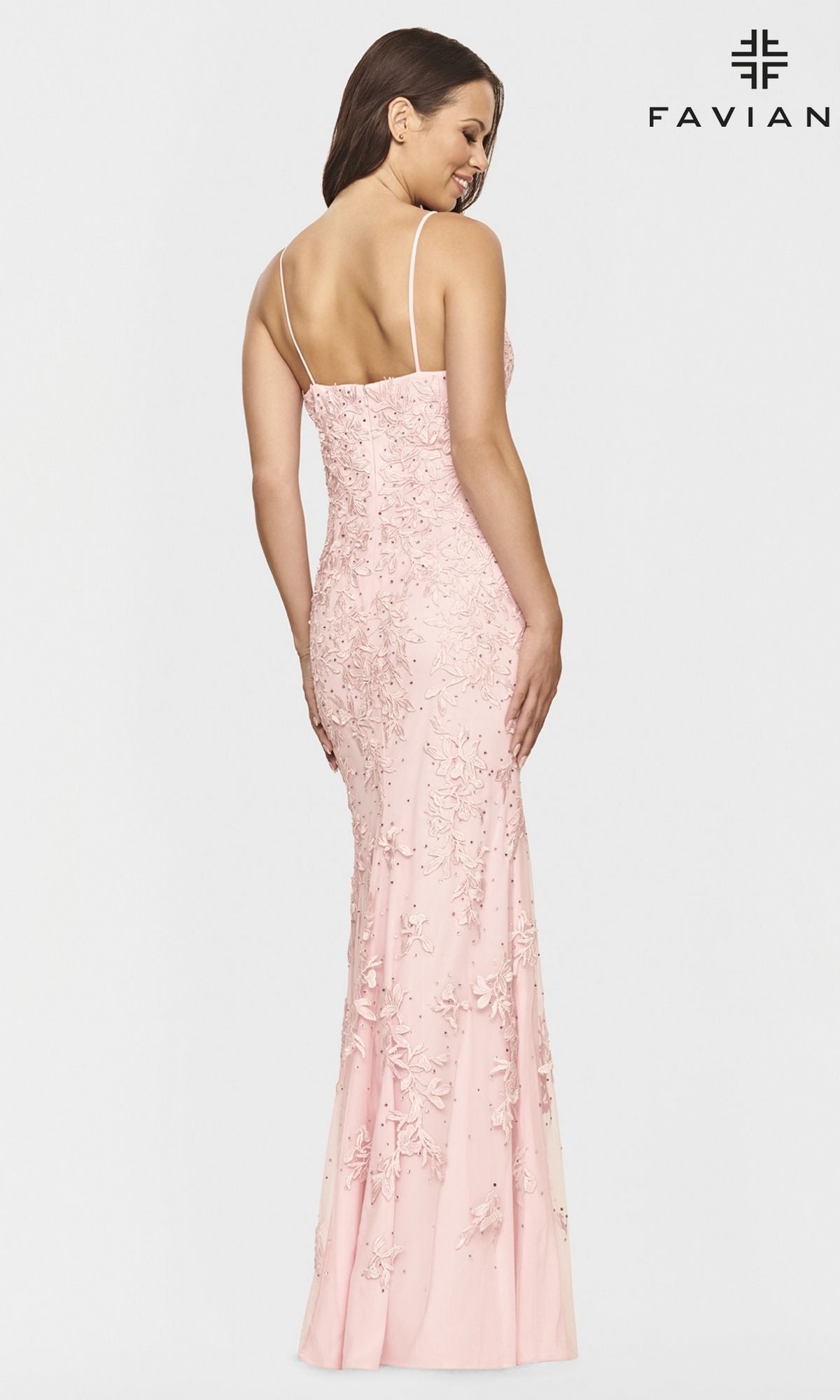 A woman is shown from the back wearing the Faviana S10812 Light Pink Lace Long Prom Dress with thin straps and floral embellishments. The brand name